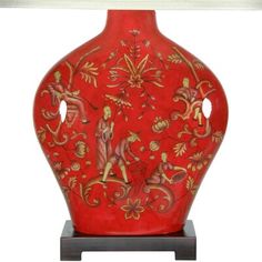 a red vase with figures painted on it