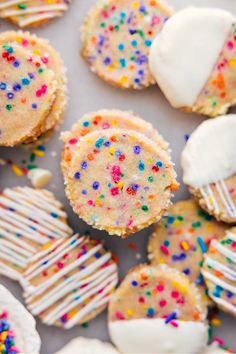 colorful sprinkles and white frosting on top of cookies