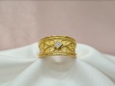 Handmade 18K solid yellow gold mat and shiny Byzantine ring with a diamond in the middle. It can be personalised for any ring size. With the ring you will receive an official gemological certificate! ❥ Free Express International Shipping ❥ Free Return within 5 days from the receiving day in case the jewel does not correspond to our site description. Features * Material: 18K Solid Yellow Gold * Gem Stones: 0.08ct Diamond * Ready to Ship in 1-3 Business Days ❥ Safety My jewellery are made ONLY for Yellow Gold Byzantine Ring For Formal Occasions, Formal Gold Byzantine Engraved Ring, Byzantine Hallmarked Engraved Wedding Ring, Formal Yellow Gold Byzantine Ring, Byzantine Style Hallmarked Engraved Wedding Ring, Formal Byzantine Yellow Gold Ring, Gold Byzantine Wedding Rings, Byzantine Ring, Christian Ring