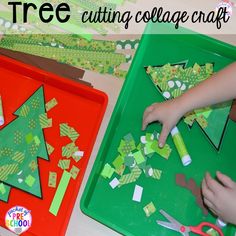 a child cutting out christmas tree shapes from construction paper