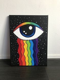 a painting of an eye with rainbows on it