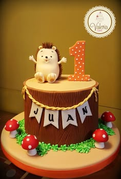 a birthday cake with a hedgehog on top and the number one for num num