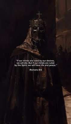 a man in a black cloak with a cross on his head and a bible verse