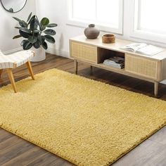 a living room with a chair, table and rug