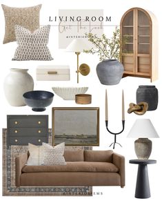 the living room is decorated in neutral tones and gold accents, including pillows, vases,