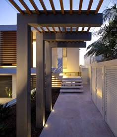 an outdoor area with benches and wooden pergols on the side of the building