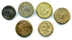 five different types of coins on a white surface