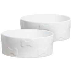 two white bowls sitting next to each other