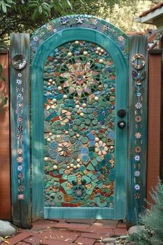 a blue door with an intricate design on the front and side doors, surrounded by plants