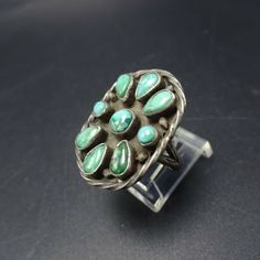 "VINTAGE NAVAJO RING DESCRIPTION: This exquisite old ring will be a treasured addition to your collection of fine vintage Native American jewelry. MEASUREMENTS: Ring face measures 1\" x 3/4\" RING SIZE: 7 WEIGHT: 7.0 grams SIGNED: no STERLING: unmarked, verified sterling silver" Untreated Southwestern Style Ring Jewelry, Southwestern Style Collectible Jewelry Ring, Southwestern Collectible Ring Jewelry, Southwestern Style Collectible Ring, Southwestern Gemstone Rings For Collectors, Vintage Oval Flower Ring, Vintage Green Turquoise Ring Stamped 925, Vintage Adjustable Green Turquoise Ring, Vintage Cabochon Round Rings