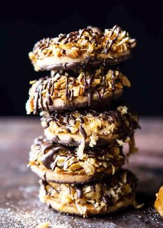 chocolate covered cookies stacked on top of each other with coconut flakes all over them