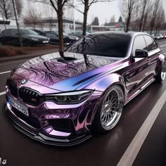 a purple bmw car parked on the side of the road in front of some cars