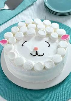 a cake decorated with marshmallows and a cat's face