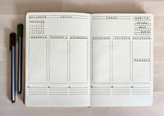 an open planner with two pencils on it