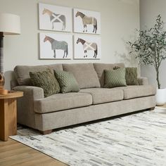 a living room filled with furniture and pictures on the wall