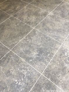 a tile floor that has been grouted with white paint