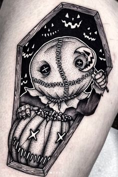 a woman's thigh with a black and white image of an owl in a box