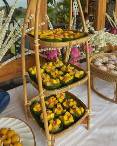 there are many trays that have food on the table in front of them with flowers