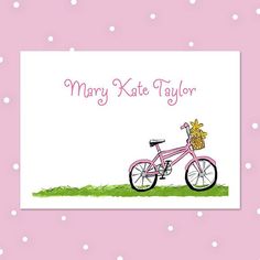 a pink bicycle with a basket on the front is shown against a polka dot background