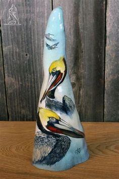 a ceramic bird sitting on top of a wooden table