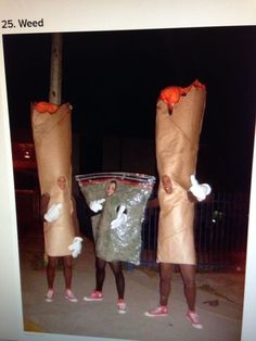 three people dressed up in costumes standing on the street with bags full of food and carrots