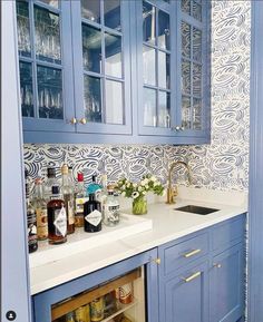 a kitchen with blue cabinets and white counter tops