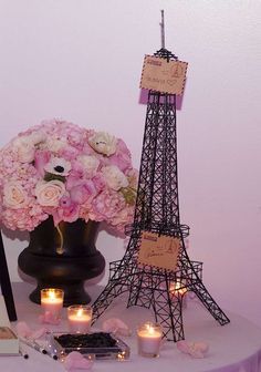 the eiffel tower is decorated with flowers and candles for an elegant wedding reception