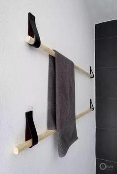 two towel racks are hanging on the wall