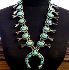 GLORIOUS OLD SQUASH BLOSSOM NECKLACE DESCRIPTION:  Breathtaking specimens of natural turquoise along with handmade Navajo pearls with filed edges. This necklace will be a valuable addition to your collection of the very finest vintage Southwestern and Native American jewelry. MEASUREMENTS:  Necklace measures 26" end to end Naja measures 2 7/8" x 2 5/8" Beads are securely strung on silver foxtail chain WEIGHT:  294.2 grams SIGNED: no STERLING:  unmarked, verified sterling silver Vintage Turquoise Jewelry, Native American Jewellery, Rodeo Jewelry, Jewelry Measurements, Turquoise Squash Blossom, Navajo Pearls, Squash Blossom Necklace, Squash Blossom, Wedding Jewellery Necklace