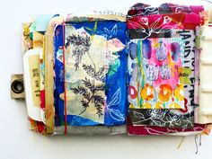 an art journal is covered in colorful fabric