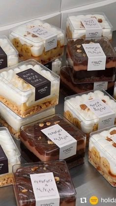 there are many different desserts on display in the glass containers with tags attached to them