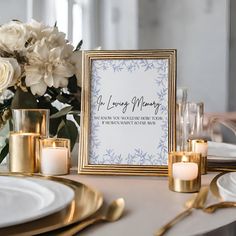 a table setting with candles and flowers on it