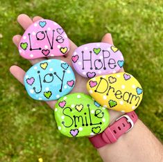 four rocks that say love hope joy dream smile