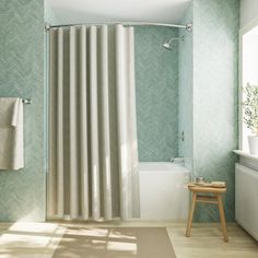 a bath room with a toilet a tub and a shower curtain next to a window