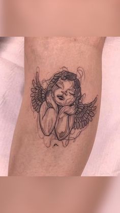 an angel tattoo on the leg