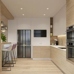 a modern kitchen with stainless steel appliances and wood flooring