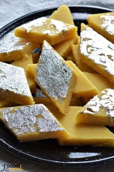 several pieces of cheese on a plate with powdered sugar