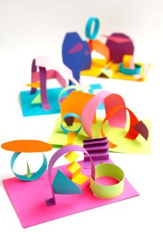 colorful paper cutouts are arranged on top of each other