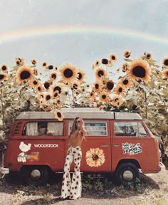 a woman standing in front of a van with sunflowers