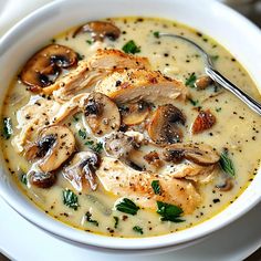 a close up of a bowl of soup with mushrooms