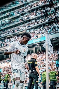 a soccer player standing on top of a field