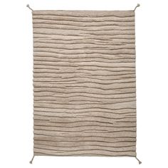 a beige rug with wavy lines on the front and back of it, against a white background