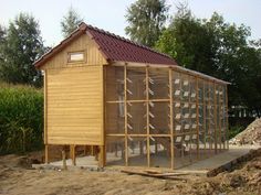 a small wooden building sitting on top of a dirt field