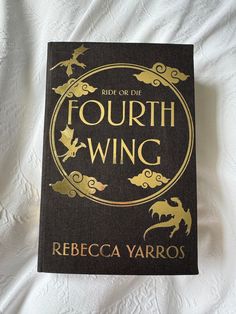 a book that is sitting on top of a white bed sheet with the title'ride on the fourth wing '