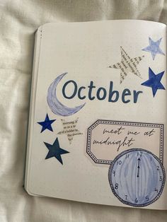 an open notebook with blue stars and the words october written in cursive writing