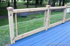 a blue deck with a wooden fence and bench