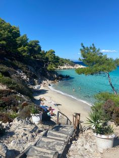 stairs lead down to the beach with clear blue water