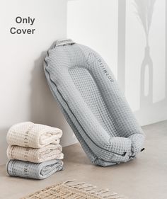 towels are stacked on the floor next to an inflatable mattress