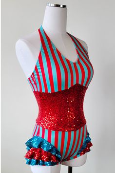 a female mannequin wearing a red, white and blue striped bathing suit with sequins