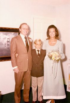 an older man and two younger men standing next to each other